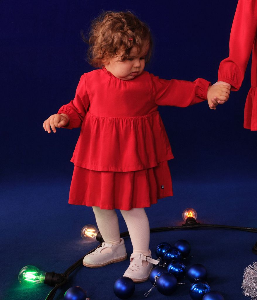 images of baby, girl, boy, and woman on a yellow curtain background