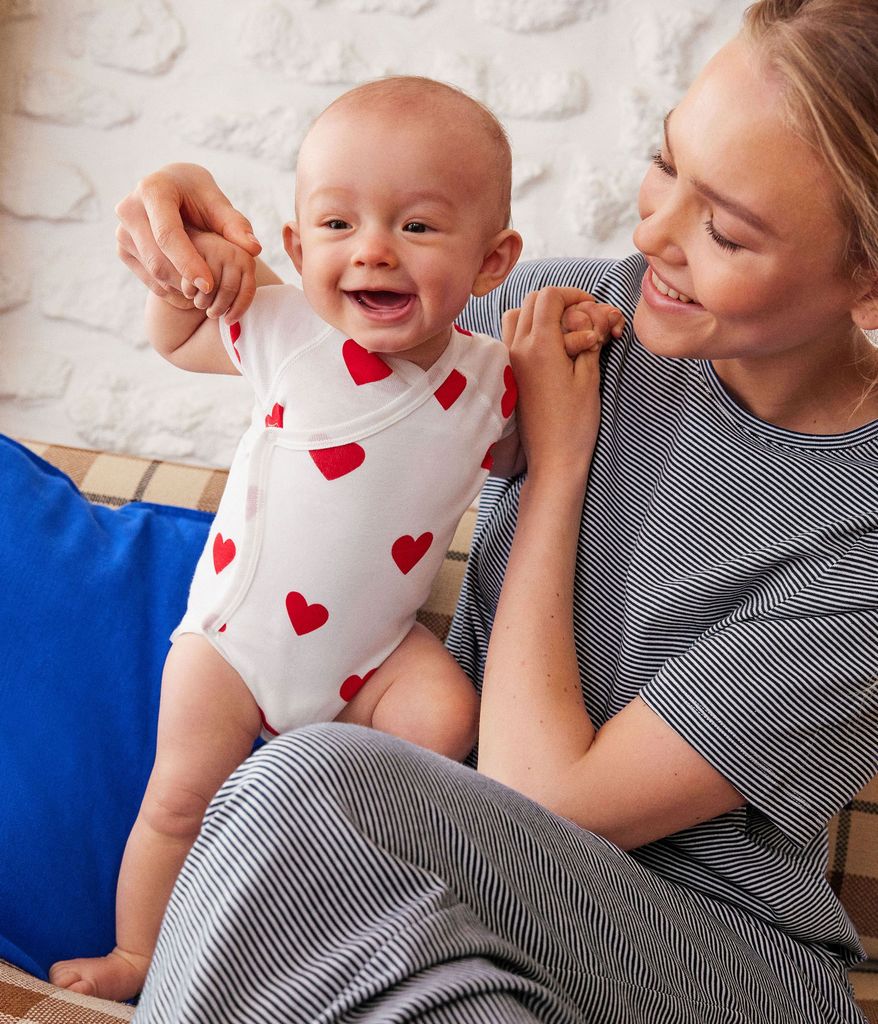 images of baby, girl, boy, and woman on a yellow curtain background