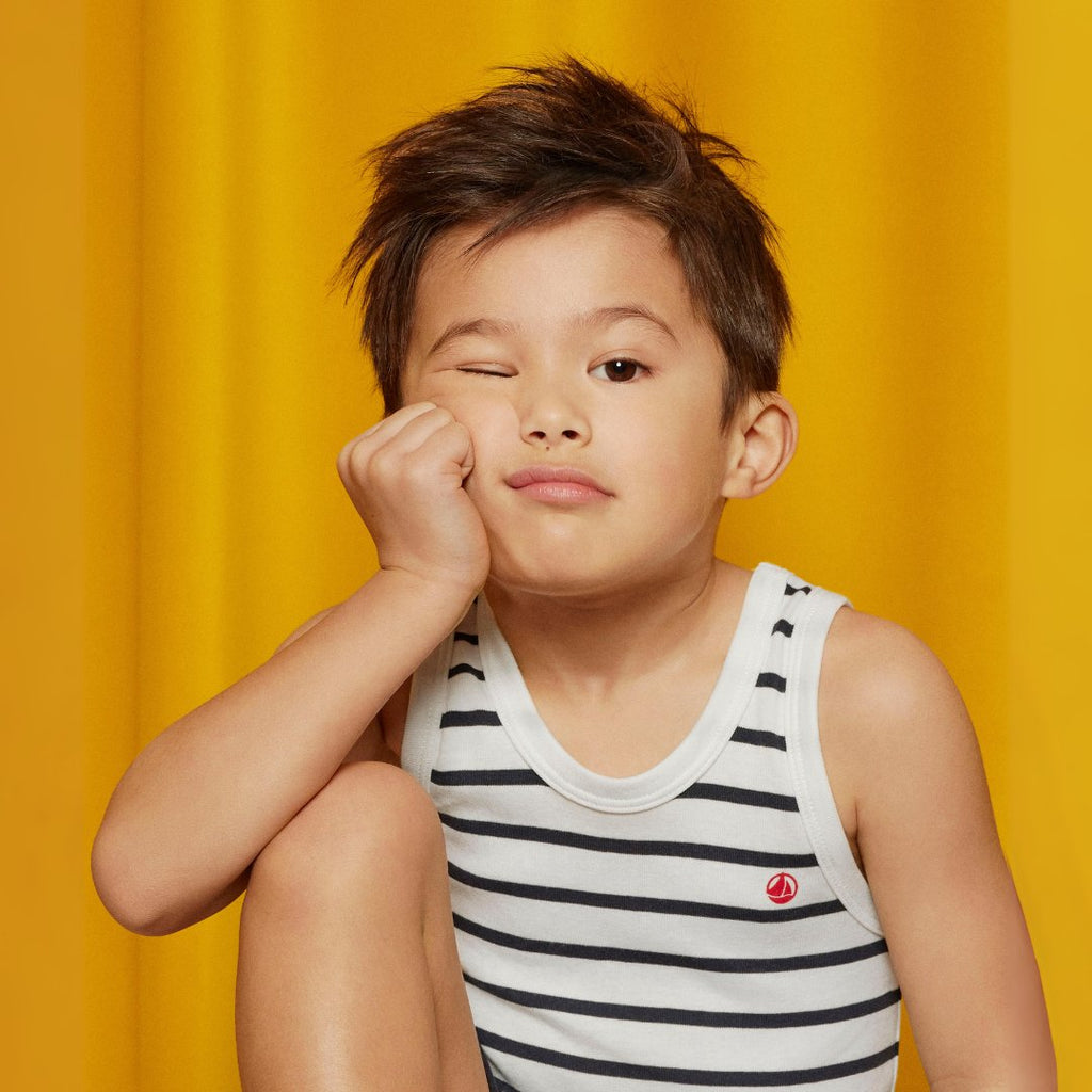 images of baby, girl, boy, and woman on a yellow curtain background