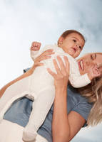 A smiling woman holding a baby