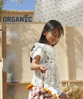 a girl holding a basket of flowers

